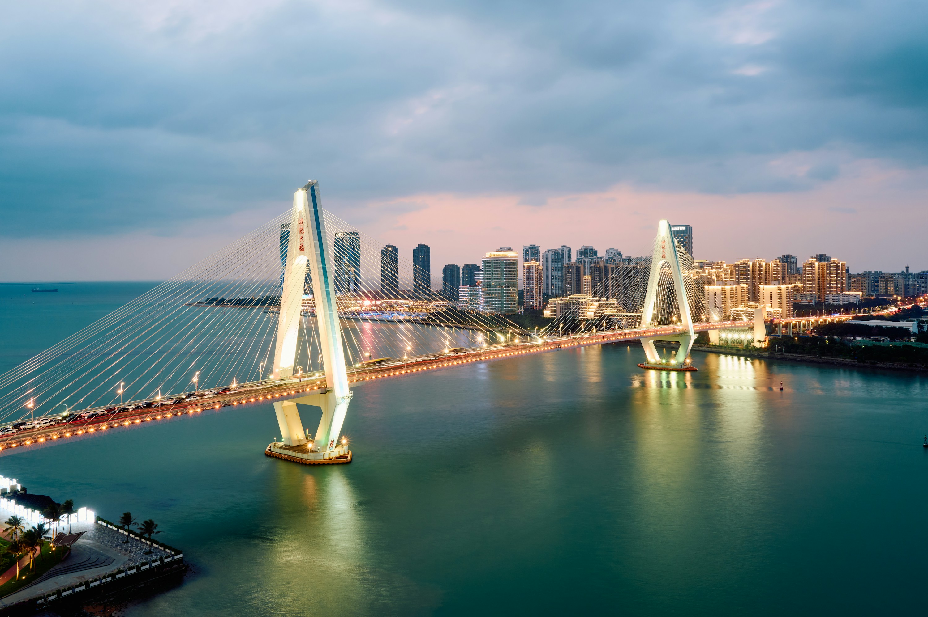Haikou Century Bridge spanning the bay at dusk